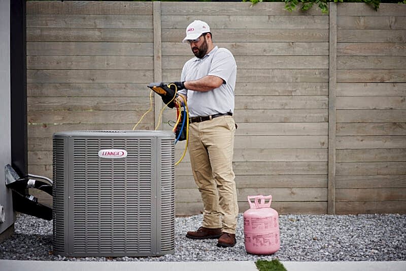technician checking levels of heating unit after replacement