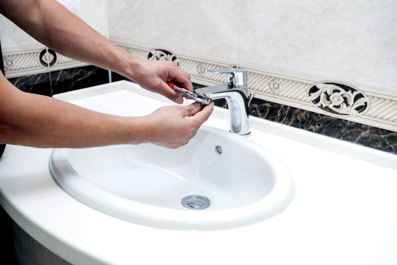 installing a faucet upgrade in a houston home's bathroom